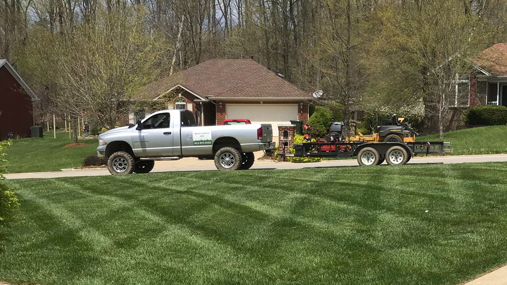 Truck trailer hauling a mower in New Albany, IN.